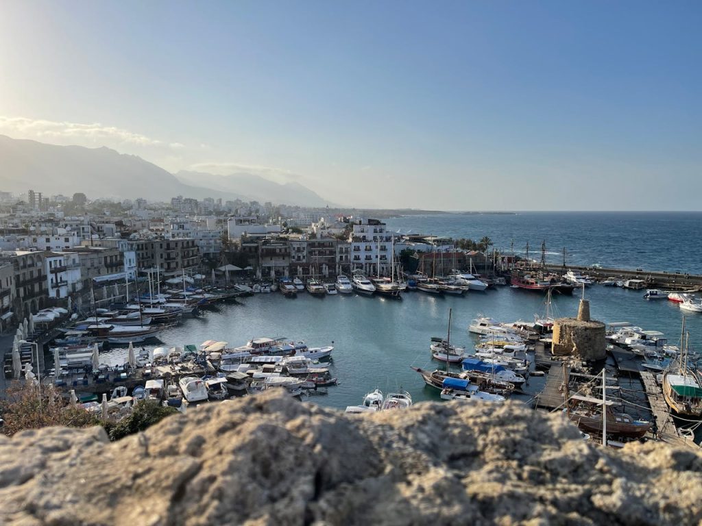 High-angle view of Kyrenia Harbor with docked boats in Cyprus, showcasing a tranquil seaside town scene.
